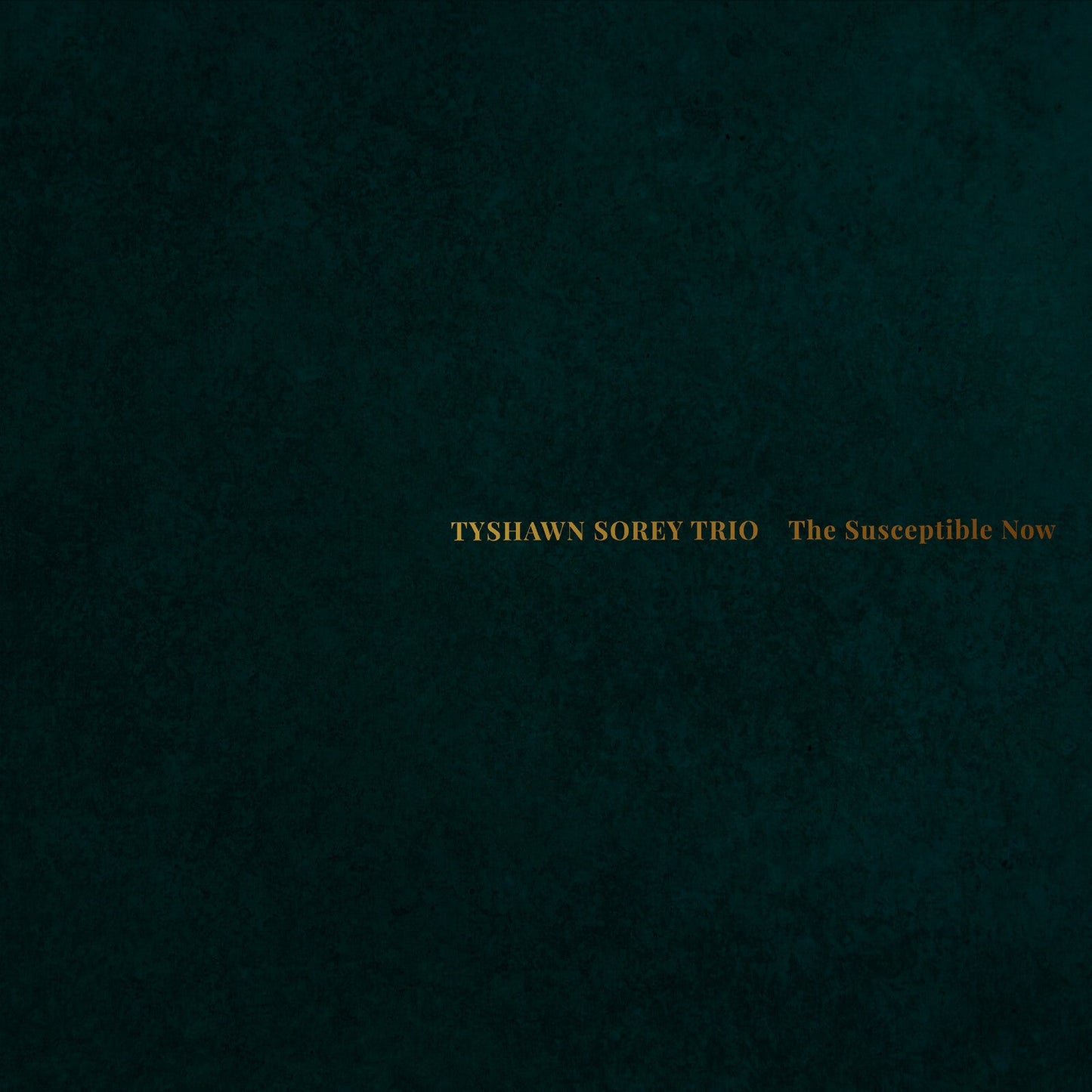 Dark teal textured album cover with gold text: "Tyshawn Sorey Trio.