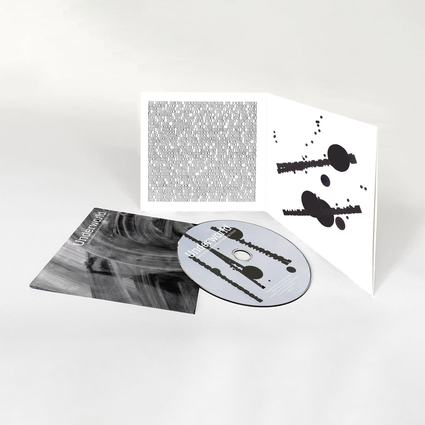 Underworld CD album with gatefold sleeve featuring abstract black and white graphic patterns.
