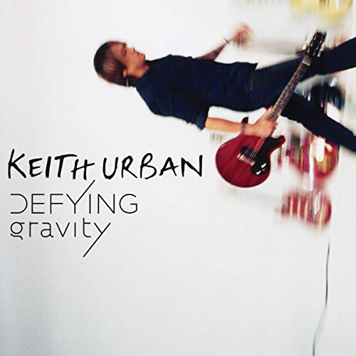 Keith Urban album cover: artist mid-air playing a red electric guitar.