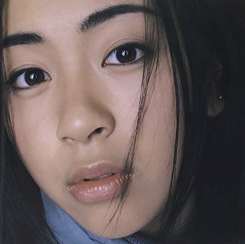 Close-up portrait of Utada Hikaru with dark hair and brown eyes.