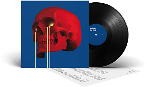 Vinyl record with red skull artwork and accompanying lyric sheet.