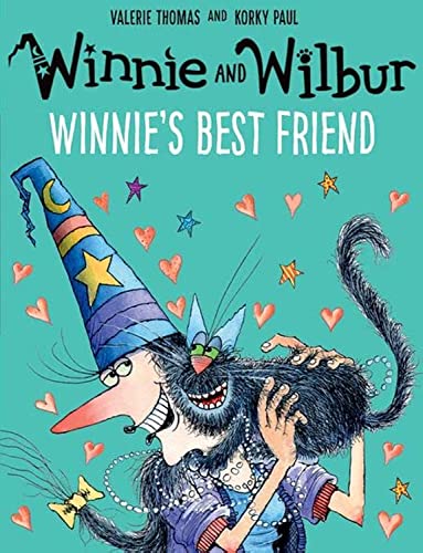 Winnie the witch wearing a blue hat holds her black cat Wilbur against turquoise.