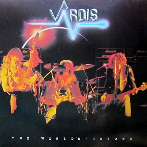 Vardis band performing on stage with a glowing logo and title text above them.
