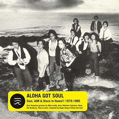 Album cover featuring a group of people on a rocky beach.