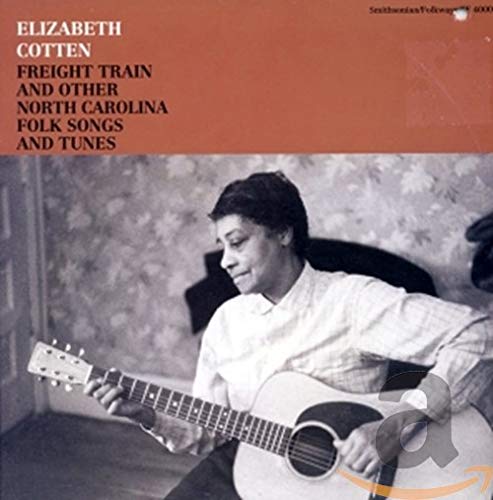 Elizabeth Cotten playing acoustic guitar on a folk album cover with orange background.