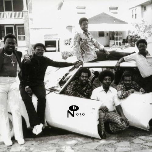 Black and white photo of a group of men with a classic car.