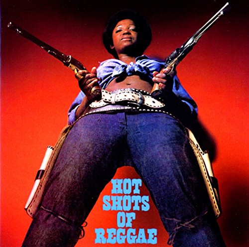 A person in jeans and a tied shirt holds two pistols against a red background.