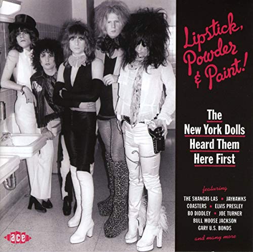 Black and white photo of five people in glam rock attire, album cover.