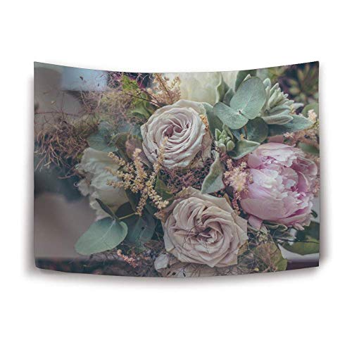 A close-up bouquet of soft pink roses, peonies, and greenery in muted tones.