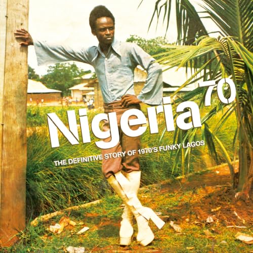 Album cover featuring a man in flared trousers standing in a lush, green landscape.