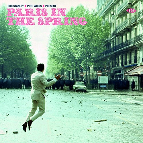 CD cover: man in white suit levitates in a Parisian street.