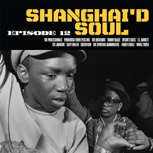 Black and white photo of two people with album title text at the top.