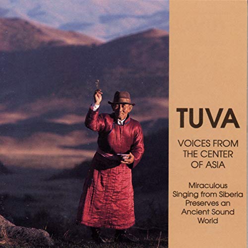 CD cover: man in red robe with mountains in the background.