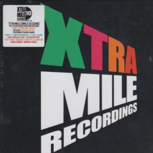 "Stack of vinyl records and CDs with 'Xtra Mile Recordings' logo on black sleeves."