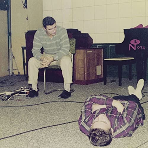 Vintage album cover featuring two people in a room with musical instruments.