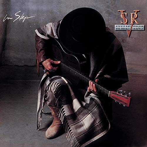 Album cover: Stevie Ray Vaughan with guitar, wearing a hat and coat.
