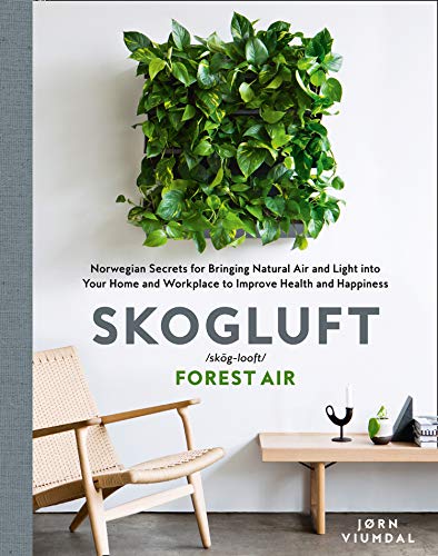 Book cover featuring a green wall of plants and a light wood chair.