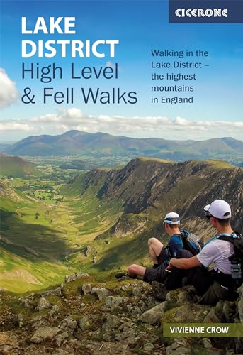 Two hikers sitting on a rocky peak overlooking a valley in the Lake District.