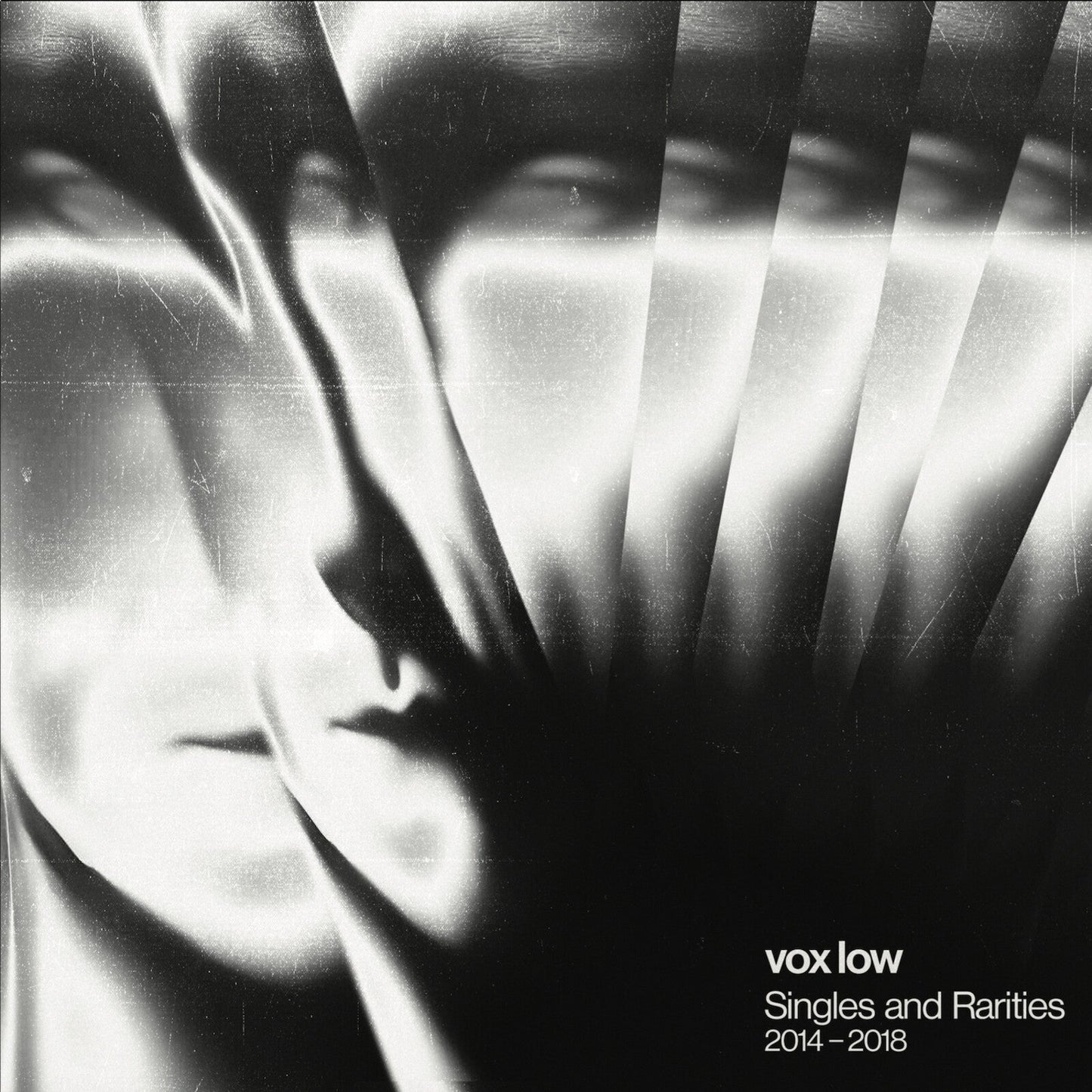 Black and white album cover with a distorted face and text.