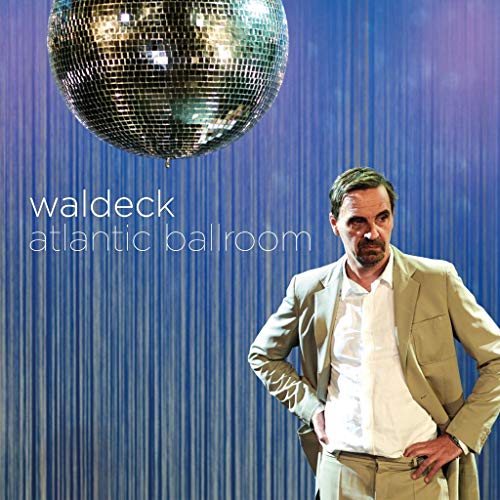 CD cover: man in suit, disco ball, and blue curtain backdrop.
