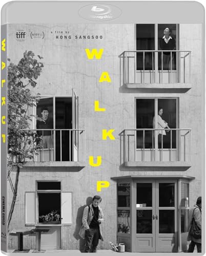 Black and white building facade with people on balconies and street level.