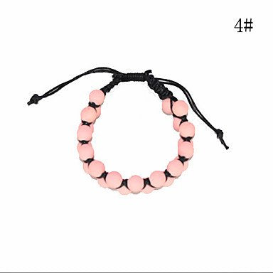 Pink beaded bracelet with black cord and adjustable knotted closure.