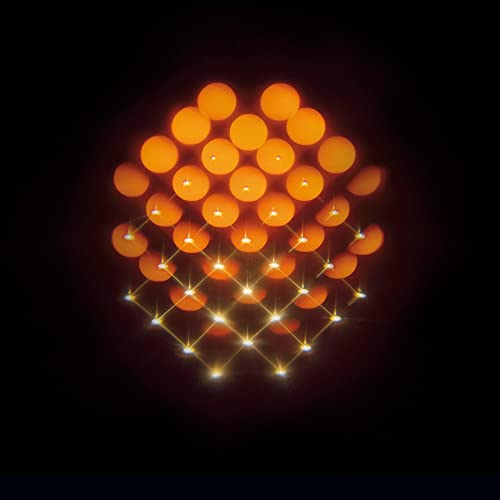 Abstract orange and yellow circles with sparkling light trails on black.