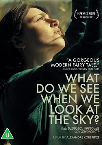A woman in a green sweater looks upward on the film cover art.