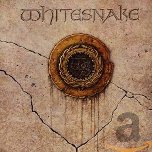 Whitesnake 1987 album cover: cracked stone texture, gold emblem, band name.