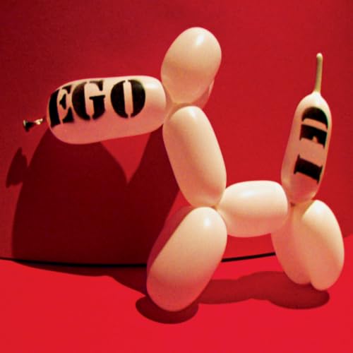 White balloon dog sculpture with black lettering against a red background.