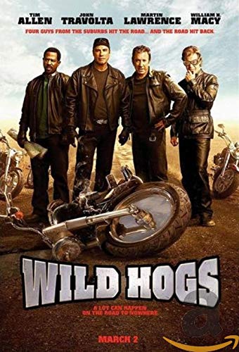 Four men in leather jackets stand behind a fallen motorcycle on a dirt road.