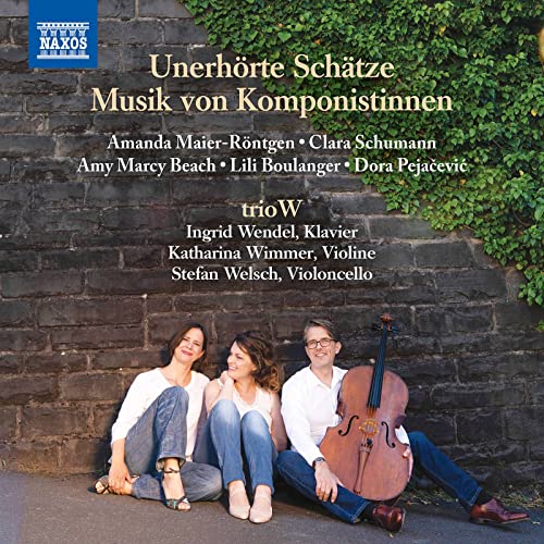 CD cover featuring three musicians with instruments against a stone wall.
