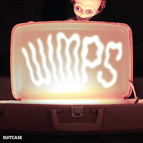 A suitcase with "Wimps" written on it in white light, with a doll peeking over.