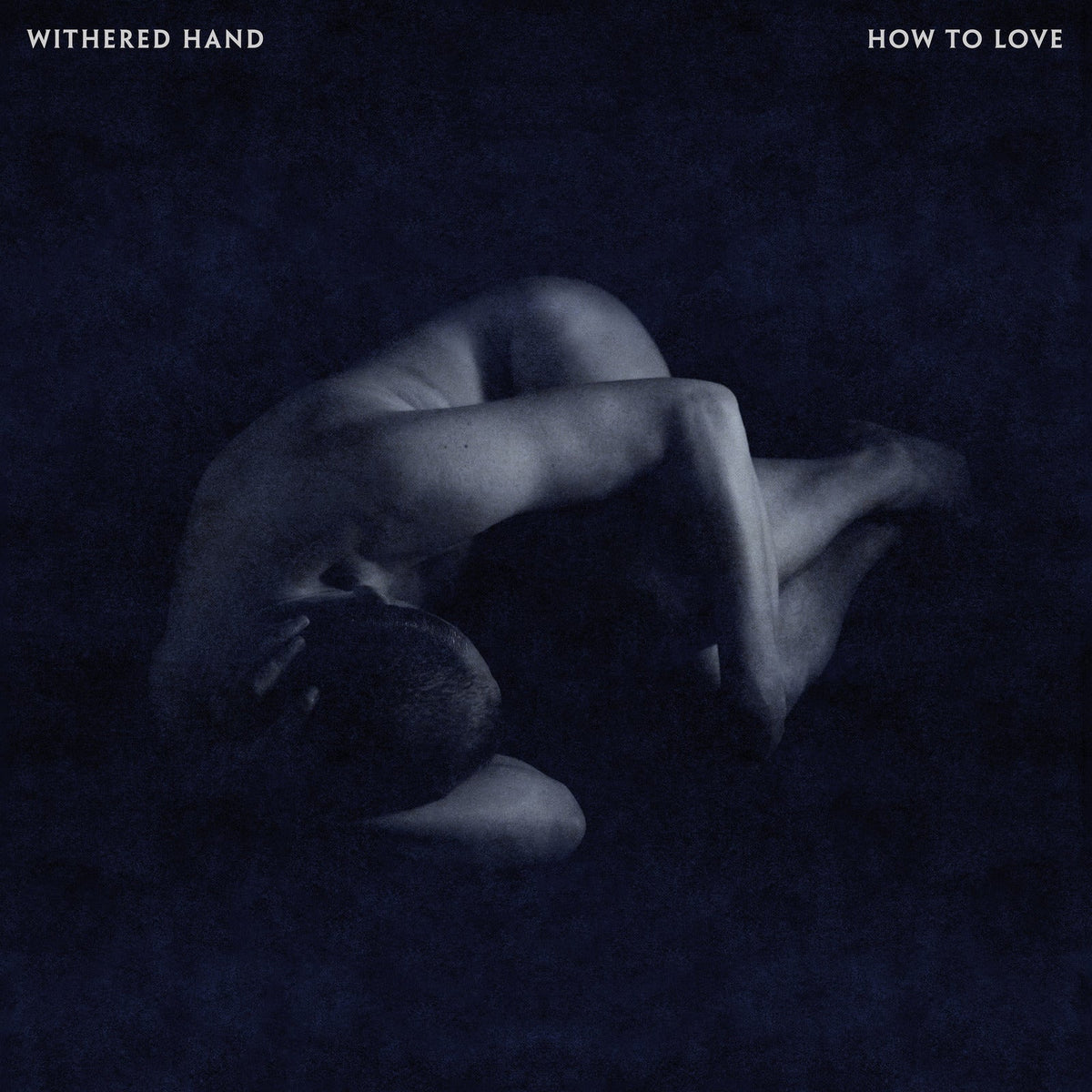 CD cover: dark, grainy image of a person curled in a fetal position.