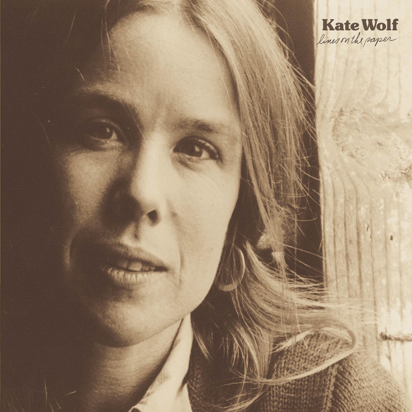 Sepia-toned close-up portrait of Kate Wolf with album title text in the upper right.