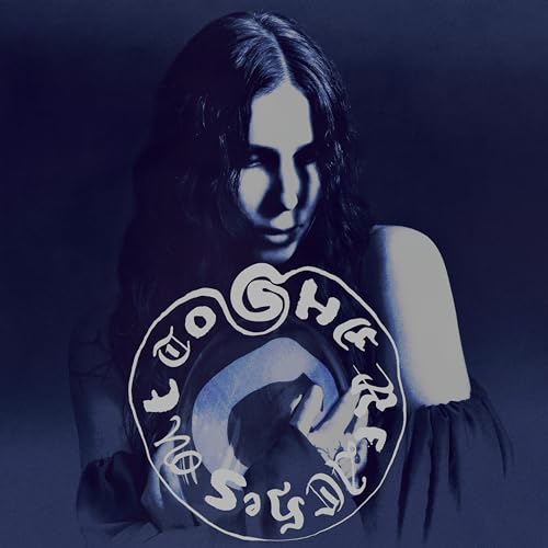 Dark blue album cover featuring a woman’s face and swirling text.