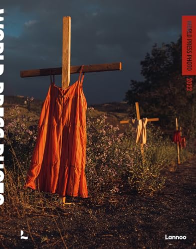 Book cover: orange dress hangs on a wooden cross in a field.