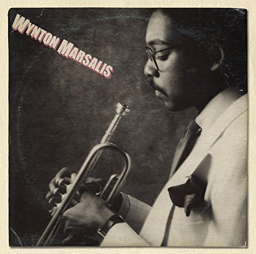 Wynton Marsalis in a white suit playing a trumpet, album cover art.