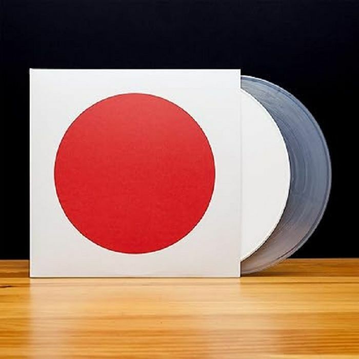 Vinyl record with a large red circle on the white cover.