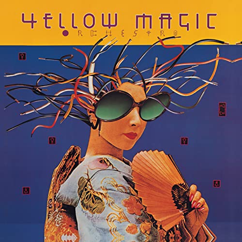 Person wearing large sunglasses and colorful wires as hair, holding a folding fan.