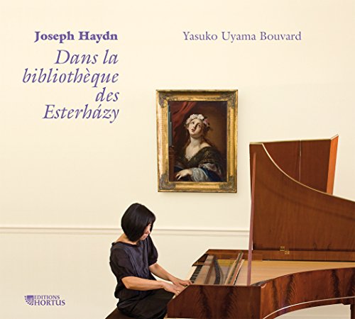 Pianist at a wooden piano with a portrait on the wall.
