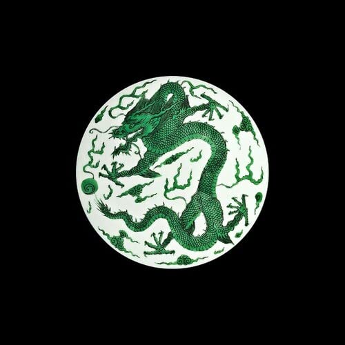Green dragon illustration on a white circular vinyl record against black.