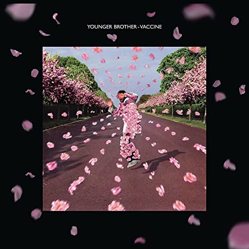 Album cover: person covered in pink petals on a road, trees.