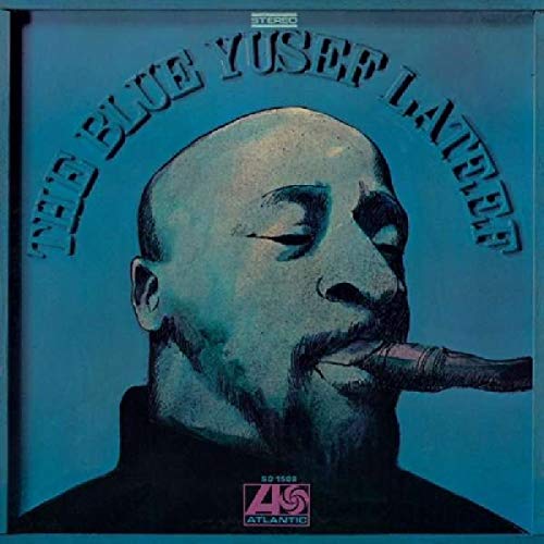 "Blue vinyl album cover with a man playing a flute, blue background."