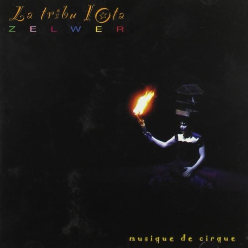 CD cover: dark image of a performer holding a flaming torch.