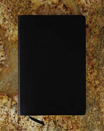 Black bonded leather Bible with a black ribbon marker on a marbled surface.