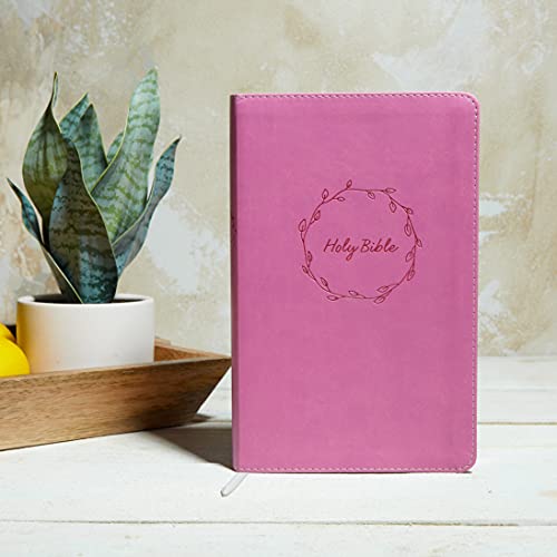Pink leather-bound Bible with “Holy Bible” embossed in a floral wreath.