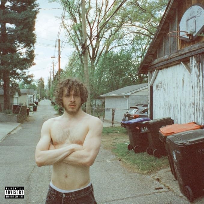"Album cover featuring a shirtless man standing on a suburban street."