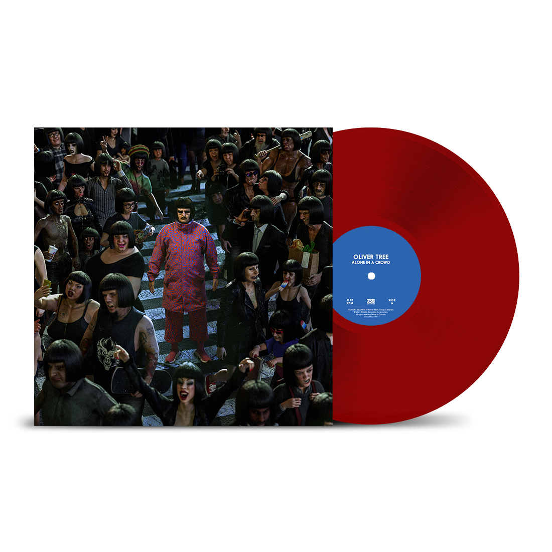 "Red vinyl record with blue label next to album cover featuring a man surrounded by people."