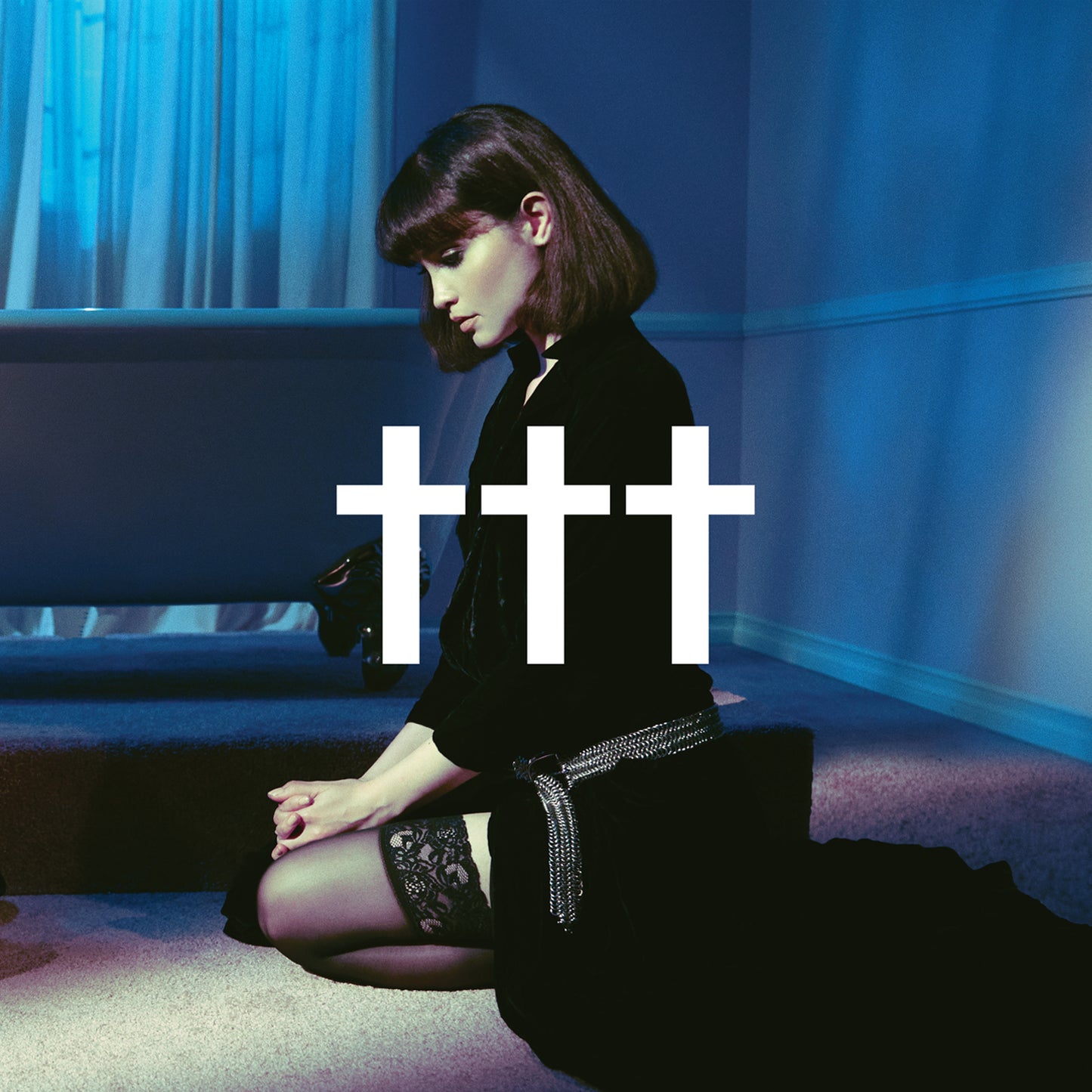 "Album cover with a kneeling woman and three white crosses on a blue background."
